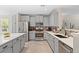 Bright, updated kitchen with stainless steel appliances, granite countertops, mosaic tile backsplash, and ample storage space at 24738 E Layton Pl, Aurora, CO 80016