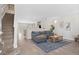 Inviting living room featuring an open floor plan, hardwood floors, modern decor, and a staircase at 24738 E Layton Pl, Aurora, CO 80016