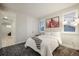 Bright bedroom with large windows, plush carpet, a comfortable bed and modern art at 4950 Saddle Iron Rd, Castle Rock, CO 80104