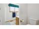 Small bathroom with toilet and window at 1411 Maple Dr, Berthoud, CO 80513