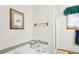 Bathroom with bathtub, shower, and window at 1411 Maple Dr, Berthoud, CO 80513