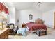 Primary bedroom with vaulted ceiling, king bed, and sitting area at 1411 Maple Dr, Berthoud, CO 80513