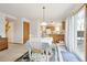 Bright dining area with table and chairs, adjacent to kitchen and living room at 1411 Maple Dr, Berthoud, CO 80513