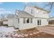 Two-story house with backyard patio and snowy landscaping at 1411 Maple Dr, Berthoud, CO 80513