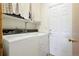 Laundry room with washer, dryer, and built-in shelving at 1411 Maple Dr, Berthoud, CO 80513