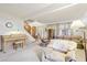 Living room with piano, rocking chair, and view of entryway at 1411 Maple Dr, Berthoud, CO 80513