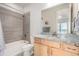 Bathroom with a granite countertop vanity, tiled shower and bathtub, and neutral color scheme at 2641 Channel Dr, Highlands Ranch, CO 80129