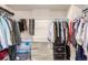 Spacious walk-in closet with ample shelving and clothing racks for organized storage at 2641 Channel Dr, Highlands Ranch, CO 80129