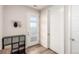 Welcoming entryway with storage shelves, coat hooks, and a bright front door with frosted windows at 2641 Channel Dr, Highlands Ranch, CO 80129