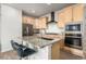 Stylish kitchen featuring stainless steel appliances, a granite island, and ample cabinet space at 2641 Channel Dr, Highlands Ranch, CO 80129