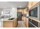 Well-equipped kitchen featuring stainless steel appliances, modern cabinetry, and views of the living area at 2641 Channel Dr, Highlands Ranch, CO 80129