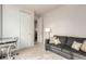 Inviting living room with neutral carpet, a gray sofa, and a bright doorway at 2641 Channel Dr, Highlands Ranch, CO 80129