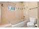 Bathroom showcasing a tub with tiled walls and decorative tile accents at 209 Saratoga Mine Dr, Castle Rock, CO 80108