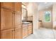 Bathroom with dual vanities, granite countertops, and linen storage at 209 Saratoga Mine Dr, Castle Rock, CO 80108