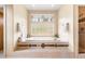 Relaxing bathroom features a soaking tub, glass block window, and a separate shower at 209 Saratoga Mine Dr, Castle Rock, CO 80108