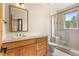 Bathroom featuring a glass enclosed shower, wood cabinets, and a large mirror at 209 Saratoga Mine Dr, Castle Rock, CO 80108