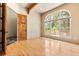 Bedroom with hardwood floors, large window with treed views, and patio access at 209 Saratoga Mine Dr, Castle Rock, CO 80108
