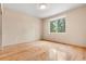 Bright bedroom featuring hardwood floors and a large window with treed view at 209 Saratoga Mine Dr, Castle Rock, CO 80108
