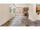 Sunlit dining room showcasing stone tile floors and views into the kitchen at 209 Saratoga Mine Dr, Castle Rock, CO 80108