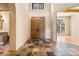 Elegant foyer with double doors, tile floors, and views to a bright living space at 209 Saratoga Mine Dr, Castle Rock, CO 80108