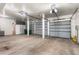 Spacious garage featuring multiple garage doors, storage, and concrete floors at 209 Saratoga Mine Dr, Castle Rock, CO 80108