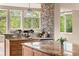 Bright eat-in kitchen features granite countertops, a stone backsplash, and a large window overlooking mature trees at 209 Saratoga Mine Dr, Castle Rock, CO 80108