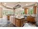 Spacious kitchen features a large center island, granite countertops, stainless steel appliances, and ample natural light at 209 Saratoga Mine Dr, Castle Rock, CO 80108