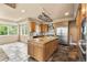 Spacious kitchen with an oversized center island, modern stainless steel appliances, and tile flooring at 209 Saratoga Mine Dr, Castle Rock, CO 80108