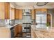 Gourmet kitchen featuring a large island, high-end appliances, and custom finishes at 209 Saratoga Mine Dr, Castle Rock, CO 80108