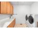 Convenient laundry room with side-by-side washer/dryer and built-in storage at 209 Saratoga Mine Dr, Castle Rock, CO 80108