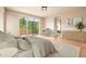 Serene bedroom with sliding glass door to outdoor patio and ensuite bathroom at 209 Saratoga Mine Dr, Castle Rock, CO 80108