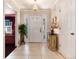 Welcoming foyer with tile flooring, elegant lighting, and a decorative accent table at 6023 E Briarwood Dr, Centennial, CO 80112