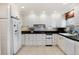 Spacious kitchen with white appliances and ample storage space in the white cabinets at 6023 E Briarwood Dr, Centennial, CO 80112