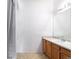 Well-lit bathroom with vanity, large mirror, and shower with white tile at 912 S Yampa St # 206, Aurora, CO 80017