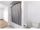 Bathroom with neutral-painted walls and featuring a shower with curtain and toilet at 912 S Yampa St # 206, Aurora, CO 80017