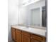 Bathroom vanity features a light countertop, wooden cabinets, a sink, and a large mirror at 912 S Yampa St # 206, Aurora, CO 80017