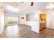 Open floor plan with living room and bar counter to kitchen with hard surface floors and sliding door to balcony at 912 S Yampa St # 206, Aurora, CO 80017