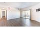 Spacious living room with hard surface floors, sliding door to balcony, and white walls at 912 S Yampa St # 206, Aurora, CO 80017