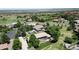 Aerial view of the neighborhood with lush greenery and stunning natural rock formations in the distance at 10886 Pheasant Run, Littleton, CO 80125