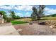 Landscaped backyard features retaining wall, fire pit, and established trees at 10886 Pheasant Run, Littleton, CO 80125