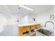 Unfinished basement features concrete floors and walls, fluorescent lights, and a wooden workbench at 10886 Pheasant Run, Littleton, CO 80125