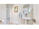 Clean half-bathroom with pedestal sink and decorative mirror at 10886 Pheasant Run, Littleton, CO 80125