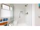 Modern bathroom with sleek glass shower featuring a built-in bench and convenient recessed shelving at 10886 Pheasant Run, Littleton, CO 80125