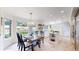 Inviting dining area featuring a wooden table, stylish chairs, and a view of the yard at 10886 Pheasant Run, Littleton, CO 80125