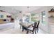 Cozy dining area with a wooden table, seating for six, and large windows at 10886 Pheasant Run, Littleton, CO 80125