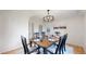 Elegant dining room with a wooden table, stylish chairs, and modern lighting at 10886 Pheasant Run, Littleton, CO 80125