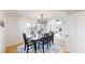 Formal dining room with a black table, six chairs, and a modern chandelier, creating an elegant ambiance at 10886 Pheasant Run, Littleton, CO 80125