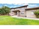 Exterior elevation of a two-story home with brick and siding, manicured lawn, and mature trees at 10886 Pheasant Run, Littleton, CO 80125