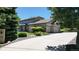 Charming two-story home boasts a long driveway, mature trees, and a well-maintained lawn at 10886 Pheasant Run, Littleton, CO 80125