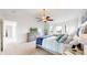 Serene main bedroom with natural light, plush carpets, and an elegant ceiling fan at 10886 Pheasant Run, Littleton, CO 80125